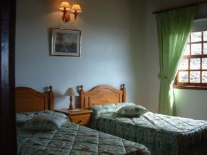Ένα ή περισσότερα κρεβάτια σε δωμάτιο στο House the Viñas 2 With views of the sea, the mountains and the volcanoes