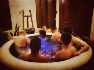 a group of men in a bath tub at The Naked House - Hotel Nudista in Nemocón