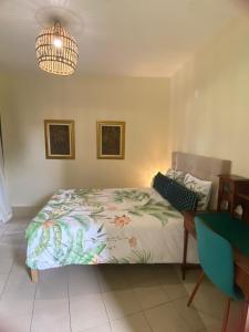 a bedroom with a bed and a chandelier at Dazk Golden Estate in Ribeira Brava