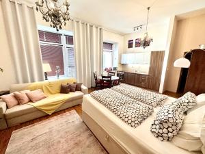 a living room with a large bed and a couch at Home Away central apartment in Poprad