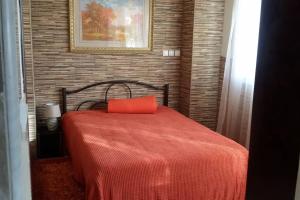 a bedroom with a red bed with a red pillow at Sofaki Apartments in Thessaloniki