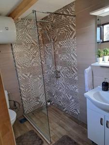 a bathroom with a shower and a sink at Olive & sea, Luxury two bedrooms cabin for 8 in Ulcinj