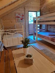a bedroom with two bunk beds and a table at Olive & sea, Luxury two bedrooms cabin for 8 in Ulcinj