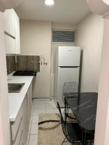 a small kitchen with a table and a refrigerator at Sisli Centre Lux in Istanbul
