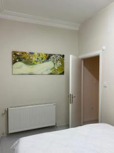 a bedroom with a bed and a painting on the wall at Sisli Centre Lux in Istanbul
