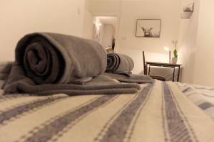 a bed with blankets and pillows on top of it at Apartment in West Yorkshire in Keighley