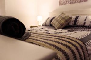 a bedroom with a bed with a blanket on it at Apartment in West Yorkshire in Keighley