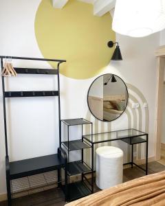 a room with two black shelves and a mirror at Wioska w Sowich Sokolec in Sokolec