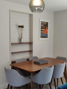 een eetkamer met een houten tafel en stoelen bij Crow's Nest Glandore - 2 - Self Catering in Glandore