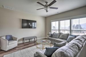 a living room with a couch and a ceiling fan at Scenic Mtn Retreat with Wooded Backyard and Fire Pit! in Chattanooga