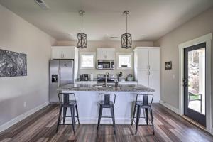 a kitchen with a counter and two bar stools at Scenic Mtn Retreat with Wooded Backyard and Fire Pit! in Chattanooga