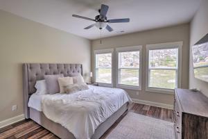 a bedroom with a bed and a ceiling fan at Scenic Mtn Retreat with Wooded Backyard and Fire Pit! in Chattanooga
