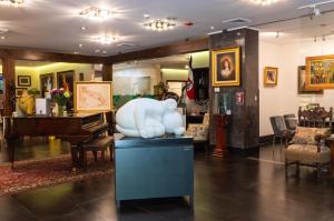 a store with a bear statue and a piano at Studio Hotel Boutique in San José