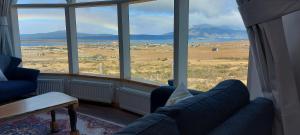 a living room with a view of a field and mountains at Dome with Stunning Glacier & Mountain Views in Puerto Natales