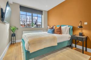 a bedroom with a bed and a window at Be London - The Islington Residences in London