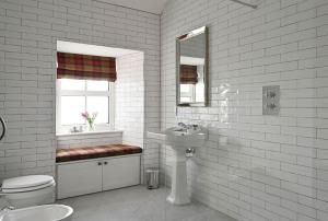 a white bathroom with a sink and a toilet at Kipney Farmhouse with hot tub in Perth +56 photos