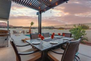 a dining table and chairs on a patio at Ocotillo 70 Red Mountain View Resort, Private Pool & Hot Tub in Santa Clara