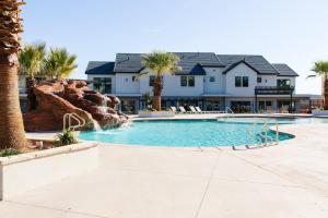 a swimming pool with a water slide in front of a house at Ocotillo 70 Red Mountain View Resort, Private Pool & Hot Tub in Santa Clara