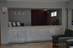a lobby with a reception counter in a building at Hotel Impala Veracruz in Veracruz