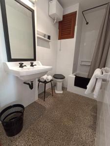 a bathroom with a sink and a shower and a toilet at Hostal Santa Ana in Lloret de Mar