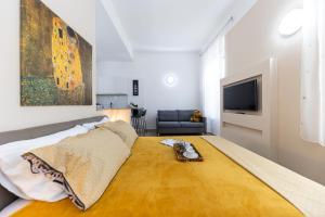 a bedroom with a large bed and a television at Apartments & Rooms Kolovare Beach in Zadar