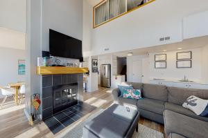 a living room with a couch and a fireplace at Chateau Ridge 223 in Blue Mountains