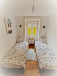 1 dormitorio con 2 camas y ventana en Lisbon House Misericordia, en Lisboa