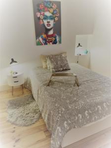 a bedroom with a bed with a painting on the wall at Lisbon House Misericordia in Lisbon