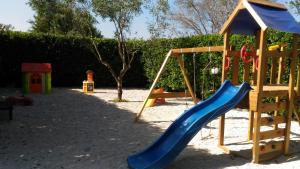 a playground with a blue slide and a swing at L'Antico Casale Fulaciano in Galatone