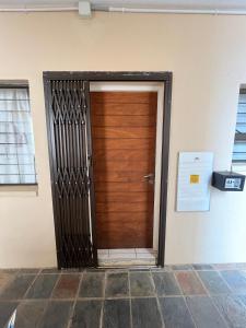 a wooden door in the side of a building at Beach Escape on the coast at apartment 78 Sancta Maria in Amanzimtoti