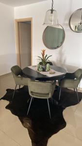 a dining room table with chairs and a mirror at Little John Luxury Apartment in Piraeus