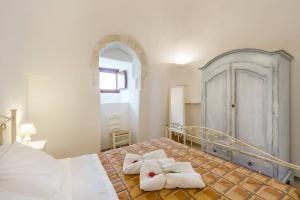 Postel nebo postele na pokoji v ubytování Masseria Trulli sull'Aia