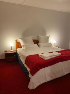 a bedroom with a large bed with two towels on it at Kaiserburg Apartment in Nuremberg