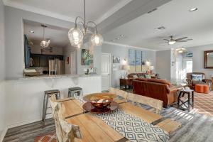 a kitchen and living room with a wooden table at Barefoot Retreat MC15 in Port Aransas