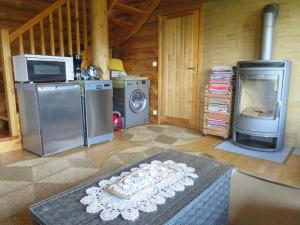 a living room with a stove and a washer and dryer at Saunaga külalistemaja, Tartust 9km kaugusel 