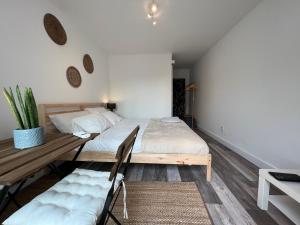 a bedroom with a bed and a table and a couch at IN-Cascais Suite Deluxe com pátio privado in Cascais