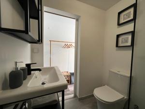 a bathroom with a sink and a toilet at IN-Cascais Suite Deluxe com pátio privado in Cascais