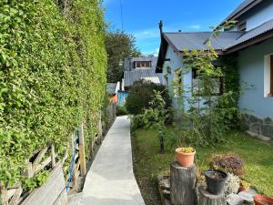 un jardín con una valla y una casa en Mirador del bosque en Ushuaia