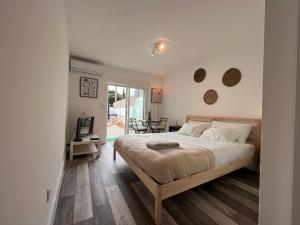 a bedroom with a bed and a television in it at IN-Cascais Suite Deluxe com pátio privado in Cascais