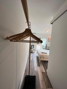 a room with a bed and a wooden floor with a ceiling at IN-Cascais Suite Deluxe com pátio privado in Cascais