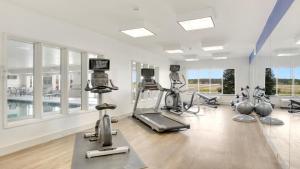 a gym with treadmills and ellipticals in a room at Holiday Inn Express Hotel & Suites Portland, an IHG Hotel in Portland