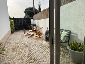 an open door to a patio with a table and chairs at IN-Cascais Suite Deluxe com pátio privado in Cascais