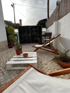 a patio with potted plants and a table at IN-Cascais Suite Deluxe com pátio privado in Cascais
