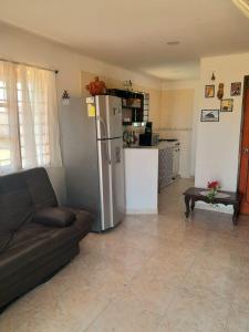 a living room with a couch and a refrigerator at Jilymar Cabaña de descanso, Isla de Barú - Cartagena in Santa Ana