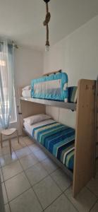 a bedroom with two bunk beds and a chair at La Via dei Trabocchi in San Vito Chietino