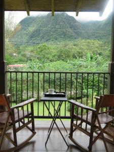 a table and two chairs on a balcony with a view at Vista Gaital/ Gaital View in Antón