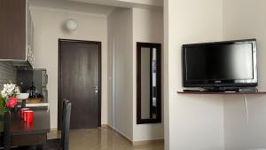 a living room with a flat screen tv on a wall at Summer Dreams in Ksamil