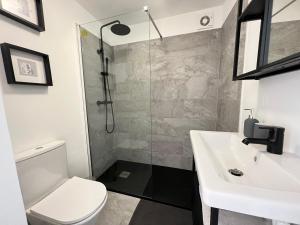 a bathroom with a shower and a toilet and a sink at IN-Cascais Suite Deluxe com pátio privado in Cascais