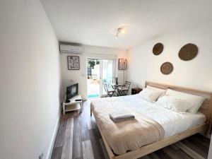 a bedroom with a bed and a television in it at IN-Cascais Suite Deluxe com pátio privado in Cascais