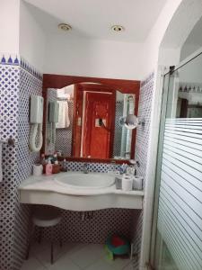 a bathroom with a sink and a large mirror at Domina coral bay Sultan - private room in Sharm El Sheikh